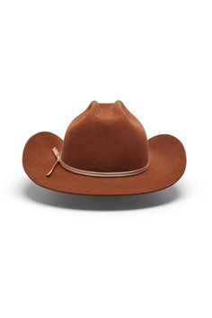 Discover Texas Tea—a warm brown cowboy hat with an unmistakable presence and refined edge. Crafted with a slightly shorter, sharply curved flanged brim, Texas Tea commands attention with its distinctive silhouette. The crown showcases a slimmer brick crease inspired by classic cattleman styling, accented with a “mule kick” at the front, while a cream 2-ply ribbon hatband adds an elegant touch. Inside, a limited-edition satin liner and leather sweatband, offer unparalleled comfort. Texas Tea is w Classic Brown Hat Bands For Riding, Fitted Western Brown Hat Bands, Classic Brown Fedora For Ranch, Fitted Brown Western Hat Bands, Classic Brown Fedora For Western-themed Events, Fitted Brown Fedora For Ranch, Classic Brown Western Fedora, Classic Brown Fedora For Western Style, Fitted Brown Western Hat