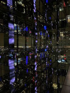 an image of a city at night from the top of a building with lots of windows