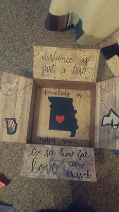 some wooden signs that are on the ground with words written in them and one has a red heart