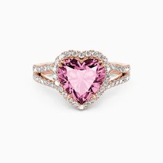 a pink heart shaped ring with diamonds around it