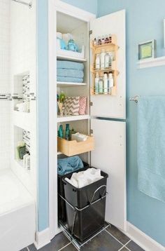 a bathroom with blue walls and white cabinets