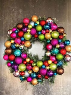 a christmas wreath with ornaments hanging from it