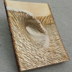 a wooden sculpture depicting a wave in the ocean