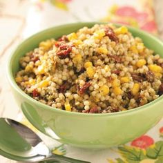 a green bowl filled with food on top of a table