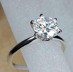 a close up of a ring with a diamond on it