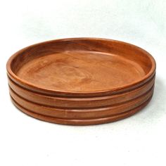 four wooden plates stacked on top of each other