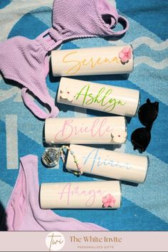 four personalized toothbrushes are laying on a towel with the names of bride and groom