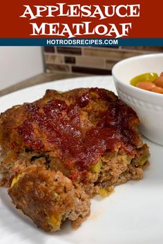 meatloaf with cranberry sauce and carrots on a white plate next to a bowl