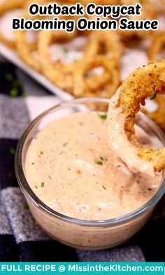 an onion rings dipping sauce in a glass bowl with the text, outback copycat blooming onion sauce