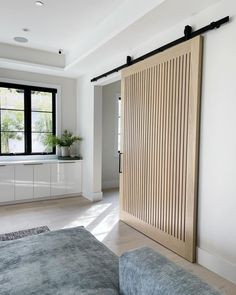 a living room with a sliding door in the middle and a couch next to it