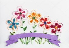 colorful paper flowers and ribbon on white background with space for text or image stock photo