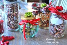 three jars filled with different types of candies and candy canes on top of a wooden table