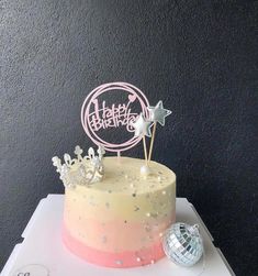 a birthday cake decorated with stars and sparkles