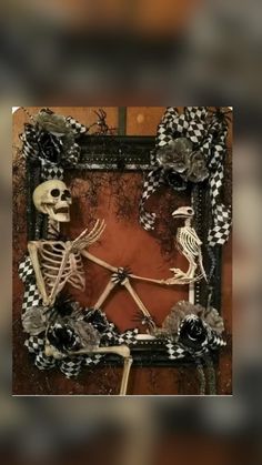 two skeletons sitting in front of a mirror with black and white decorations on it's sides