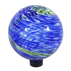 a blue glass ball with green and white swirls on the outside, sitting on a black stand