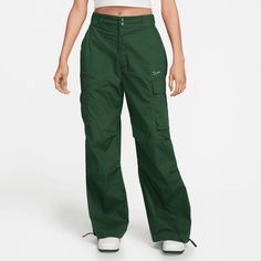 Style No. FV4969-323 Color: Fir Green Match functionality with throwback style in this fresh take on a favorite. These roomy utility pants feature cargo pockets for quick and easy storage. Their durable woven fabric is fully lined—but still lightweight. Plus, ties at the leg openings let you customize your look. Pockets provide quick storage for keys, phone and cold hands. Cinch ties at leg openings to show off your favorite kicks. Nike Sportswear Women's High-Waisted Loose Woven Pants. Nike Cargo Pants, Nike Sportswear Women, Cargo Pants Outfit, Green Cargo Pants, Green Cargo, Woman Weaving, Green Pants, High Rise Pants, Nike Pants