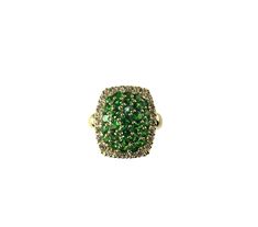 a ring with green and white stones on it