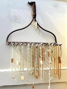 an old coat rack with beads hanging from it