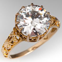 an antique style diamond ring with filigree accents