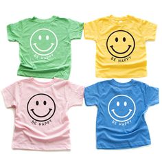 four t - shirts with smiley faces on them, all in different colors and sizes