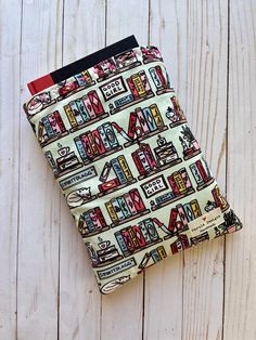 Protect your tablet or books in a bag or backpack with a booksleeve! Each sleeve is padded with a layer of cotton batting and lined with a unique, coordinating fabric. Each booksleeve can hold 1-3 paperback books, 1-2 hardcover books, or an iPad. Approximately 9" x 11". Sleeve size may vary by 1/4". Please note that all of our items are homemade. Any uneven stitches are just human error :) Book Protector, Book Pouch, Hardcover Books, Book Sleeve, Coordinating Fabrics, Pad Cover, Book Accessories, Hardcover Book, Paperback Books