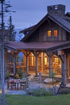 a large wooden house in the woods at night