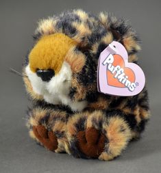 a stuffed animal with a heart shaped tag on it's ear and the word ruffins written on its chest