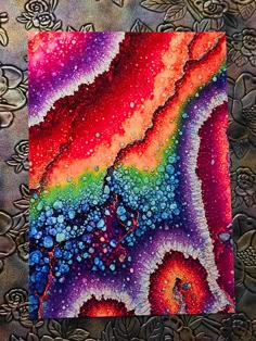 an abstract painting with colorful colors and bubbles on it's surface, in the middle of