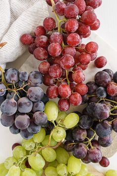 grapes and other fruits are arranged on a plate