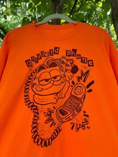 Garfield Phone T Shirt Easy 30 day return policy Garfield Pjs, Garfield Outfit, Garfield Phone, Garfield T Shirt, Garfield Shirt, Silly Clothes, Silly Shirt, Funky Outfits, Cool Graphic Tees