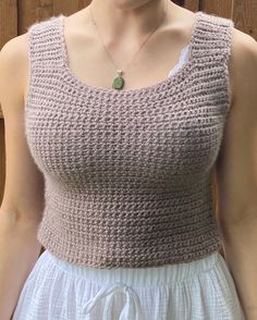 The crochet construction of the tank top adds a charming handmade touch, creating a delicate and intricate texture that adds visual interest and depth to the design. Whether you're lounging at home, heading to the beach, or meeting friends for brunch, our crochet tank top adds a touch of bohemian flair to your look. Embrace laid-back elegance with our Crochet Purple/Tan Tank Top and elevate your look with a touch of bohemian charm. Whether you're running errands around town or relaxing at home, our tank top is the perfect choice for effortless style and comfort all season long. Knit Crochet Tank Top Vest, Fitted Sleeveless Crochet Top With Knit Fabrication, Sleeveless Fitted Knitted Top, Sleeveless Crochet Knit Crop Top, Fitted Crochet Knit Tank Top, Sleeveless Knit Tops With Crochet Lace, Sleeveless Crochet Lace Knit Crop Top, Fitted Crochet Sleeveless Tops, Bohemian Knit Sleeveless Crop Top