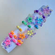 "These matching rainbow Kandi bracelets are perfect to wear, gift to your rave fam, or trade! Stand out at any rave or festival with vibrant UV-reactive Star charms. Bracelet length: 7\" Each bracelet pack includes: Pink/Red, Orange, Yellow, Green, Blue, & Purple All items are hand-made on white elastic jewelry string and triple-knotted to ensure the best stretch and durability. As a thank you, every order also includes FREE GIFTS! (Bigger orders = bigger gifts 😊)" Personalized Multicolor Rave Bracelets, Rainbow Rave Jewelry With Colorful Beads, Rainbow Beaded Bracelets For Gifts, Rave Style, Rainbow Road Kandi Cuff, Rainbow Kandi Cuff, Kandi Necklace, Trendy Chokers, Rave Accessories, Bracelet Pack