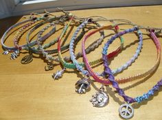 several bracelets with charms are sitting on a table