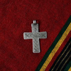 Antique handmade silver cross pendant from Ethiopia crafted by a local Amhara silversmith by melting and casting silver coins such as Maria Maria Thaler's, showcasing the intricate artistry and religious significance of Ethiopian Orthodox Coptic Christian culture.  This old silver cross measures 60 x 45 mm. What you see is what you get. Artisan Engraved Cross Pendant Jewelry, Engraved Cross Necklace For Blessing, Traditional Silver Cross Necklace, Traditional Silver Cross Necklace Gift, Traditional Silver Cross Necklace As Gift, Artisan Handmade Cross Jewelry, Silver Etched Cross Pendant Jewelry, Handmade Artisan Cross Jewelry, Spiritual Cross Jewelry For Commemoration