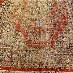 an old rug with faded colors and fringes