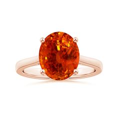 an orange sapphire ring on a white background