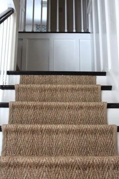 the stairs are made of carpet and have black handrails