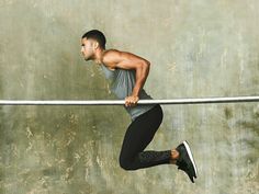 a man is doing pull ups on a bar