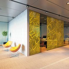 an office with yellow chairs and glass partitions on the walls that divide it from the floor