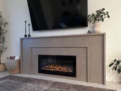 a flat screen tv mounted above a fireplace