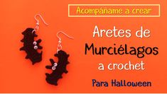 the earrings are made out of crochet and decorated with black cats on orange background