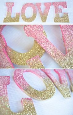 pink and gold glitter love letters are displayed on a white tablecloth with the word love spelled out