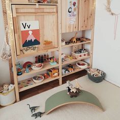 a child's playroom with toys and bookshelves on the floor in front of it