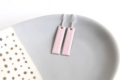 Soft pastel pink earrings handmade by firing enamel onto copper in a kiln at a temperature of over 800 degrees. The geometric rectangular earrings measure approximately 30mm x 8mm and would make a fab gift for any lover of stylish jewellery accessories. These earrings are backed with counter enamel to insure comfort and strength. They come complete with 925 Sterling silver earring wires and would look fabulous with any outfit all year round. CUSTOMISE: Please contact me if you would like a bespo Stylish Jewelry Accessories, Rectangular Earrings, Black And White Earrings, Necklace Length Guide, Multiple Earrings, Rectangle Earrings, Earring Wires, Rose Pastel, Wear Necklaces