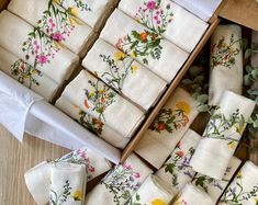 a box filled with white napkins covered in flowers