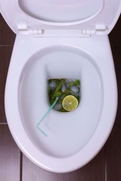 a white toilet filled with lots of ice and lemon slices