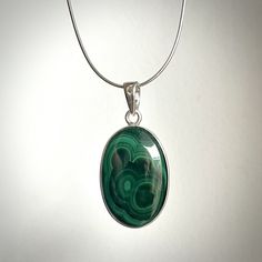 Beautiful and Unique Pendant with genuine Malachite I made it with high quality sterling silver (Ag 925) and beautiful malachite cabochon in shades of green. It is handmade what makes it very special and unique. Malachite's been used as a gemstone / material for sculptures for thousands of years. Nowadays it is quite popular to use it to make jewelry. Malachite is very unique. Each of them have naturally made shades of green going through its surface. Each of cabochons will look different , what makes each ring very individual. There is only one exactly like this so ...  .. If You like it - don't wait too long with a purchase ;)  Information: Shape of Malachite Cabochon: oval Measurements of Malachite: 32 x 20 Whole pendant measurements: Length: 47 [mm]  Width: 23 [mm]  Height/Thickness: 5 Green Polished Sterling Silver Gemstones, Green Sterling Silver Gemstones With Polished Finish, Malachite Pendant, Amber Ring, 925 Silver Jewelry, Unique Pendant, Shades Of Green, Beautiful Earrings, Natural Stones