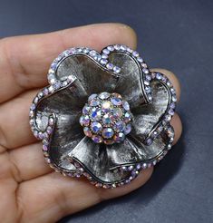 Vintage dark silver tone AB rhinestone brooch, In good vintage condition, It's 2" across 1" thick. Thanks. Silver Bling Brooches For Evening, Silver Rhinestone Brooches For Formal Occasions, Silver Rhinestone Brooches For Anniversary, Formal Silver Rhinestone Brooches, Formal Silver Brooches With Rhinestones, Silver Costume Jewelry Brooches For Party, Silver Rhinestone Brooches For Gifts, Silver Rhinestone Brooches As Gifts, Silver Sparkling Brooches For Evening