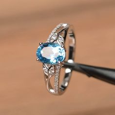 It is a Swiss blue topaz ring. The main stone is 6 mm*8 mm oval cut.weight about 1.47 carats.The basic metal is sterling silver and plated with rhodium.To change the metal to a solid gold (white/rose) or platinum is also available, please ask for a quotation if you want.You can also go to my shop Home for more elegant rings: https://www.etsy.com/shop/godjewelry?ref=hdr_shop_menu Swiss blue topaz is the November birthstone More Swiss blue topaz rings:https://www.etsy.com/shop/godjewelry?search_qu Oval Blue Topaz Ring With Accent Stones, Topaz Solitaire Birthstone Ring Oval, Oval Solitaire Blue Topaz Ring, Oval Topaz Solitaire Birthstone Ring, Oval Topaz Ring For Anniversary, Oval Blue Topaz Ring For Anniversary, Oval Blue Topaz Solitaire Ring, Oval Solitaire Topaz Birthstone Ring, Oval Topaz Anniversary Ring