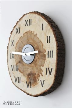 a wooden clock with roman numerals on the face is mounted on a wall